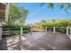 Beautiful backyard deck with trees and a grassy fenced in yard at 8626 W Utah Ave, Lakewood, CO 80232