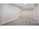 Carpeted basement area with view into another room in neutral color palette at 8626 W Utah Ave, Lakewood, CO 80232