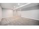 Finished basement with neutral carpet, recessed lighting, and bright white walls at 8626 W Utah Ave, Lakewood, CO 80232