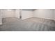 Spacious basement area with neutral walls, trim, and carpet in modern home at 8626 W Utah Ave, Lakewood, CO 80232