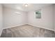 Finished basement with carpet, windows, and neutral paint and trim at 8626 W Utah Ave, Lakewood, CO 80232