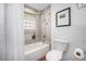 Bright bathroom with tiled shower, glass block window, and white subway tile at 8626 W Utah Ave, Lakewood, CO 80232