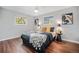 Serene bedroom featuring hardwood floors, natural light, and stylish decor with two large windows at 8626 W Utah Ave, Lakewood, CO 80232