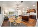 Bright dining area with a glass table set and views into the open-concept living spaces at 8626 W Utah Ave, Lakewood, CO 80232