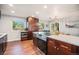 Bright kitchen featuring a cooktop island, stainless appliances, and dark wood cabinetry for storage at 8626 W Utah Ave, Lakewood, CO 80232