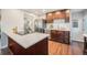 Updated kitchen showcasing stainless steel appliances, quartz countertops, and sleek, dark cabinetry at 8626 W Utah Ave, Lakewood, CO 80232