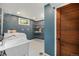 Cozy laundry room featuring storage shelves and a utility sink at 8626 W Utah Ave, Lakewood, CO 80232