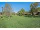 Expansive grassy lawn surrounded by mature trees offers a serene outdoor space at 8626 W Utah Ave, Lakewood, CO 80232
