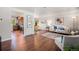 Open-concept living area featuring hardwood floors, a modern design, and access to the dining area at 8626 W Utah Ave, Lakewood, CO 80232