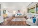 Cozy living room featuring hardwood floors, neutral decor, and lots of natural light at 8626 W Utah Ave, Lakewood, CO 80232