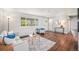 Bright living room featuring hardwood floors, stylish furniture, and lots of natural light at 8626 W Utah Ave, Lakewood, CO 80232