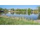 Picturesque pond with cattails and reflections of trees and buildings creates a tranquil environment at 8626 W Utah Ave, Lakewood, CO 80232