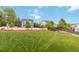 Expansive grassy backyard with white picket fence and mulched garden beds for outdoor enjoyment at 10870 Crestone Needles Dr, Parker, CO 80138