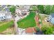 Aerial view of a large backyard featuring a deck, sport court, and lush lawn at 10870 Crestone Needles Dr, Parker, CO 80138