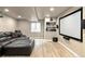 Finished basement with a leather sectional, large screen, and a projector at 10870 Crestone Needles Dr, Parker, CO 80138