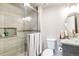 Well-lit bathroom featuring a glass shower, tiled walls, and a modern sink at 10870 Crestone Needles Dr, Parker, CO 80138