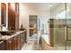 A luxurious bath connects to the main bedroom and features dual sinks, a soaking tub, and a tiled shower at 10870 Crestone Needles Dr, Parker, CO 80138