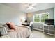 An ample bedroom features a ceiling fan, a large window, and a desk with computer at 10870 Crestone Needles Dr, Parker, CO 80138