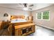 A cozy bedroom with a wooden bed frame, wood floors, and natural light at 10870 Crestone Needles Dr, Parker, CO 80138