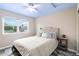 A comfortable bedroom offers a neutral color palette, a large window, and a ceiling fan at 10870 Crestone Needles Dr, Parker, CO 80138