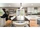 An open-concept dining room with white chairs and access to the kitchen at 10870 Crestone Needles Dr, Parker, CO 80138