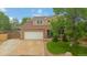 Traditional two-story home showcasing a neat lawn and an attached two-car garage at 10870 Crestone Needles Dr, Parker, CO 80138