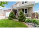 Charming home featuring a well-manicured lawn, tidy landscaping, and attractive brick accents at 10870 Crestone Needles Dr, Parker, CO 80138