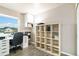 An office space with a large window, shelving unit, desk, and comfortable chair at 10870 Crestone Needles Dr, Parker, CO 80138