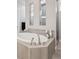 Luxurious soaking tub with mosaic tile accent, modern fixtures, and glass-enclosed shower at 6970 E Lake Dr, Centennial, CO 80111