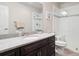 Modern bathroom with granite countertop, sleek vanity, and glass-enclosed shower at 6970 E Lake Dr, Centennial, CO 80111