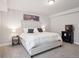 Well-lit bedroom with cozy carpet and a large bed with a tufted headboard and stylish bedside tables at 6970 E Lake Dr, Centennial, CO 80111