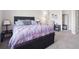 Well-lit bedroom showcasing a tufted headboard and soft, inviting bedding at 6970 E Lake Dr, Centennial, CO 80111