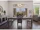 Dining room with ornate table and chairs, buffet, chandelier, and large windows looking out to the yard at 6970 E Lake Dr, Centennial, CO 80111