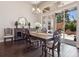 Dining room features modern table with ornate chairs, buffet, chandelier and sliding door access to outside patio at 6970 E Lake Dr, Centennial, CO 80111