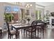 Bright dining room featuring hardwood floors, decorative chandelier, and access to outdoor patio at 6970 E Lake Dr, Centennial, CO 80111