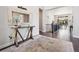 Open entryway with hardwood floors, decorative table, and a view of the living spaces at 6970 E Lake Dr, Centennial, CO 80111