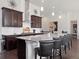 Kitchen with stainless steel appliances, dark wood cabinets, granite countertops, and island with seating at 6970 E Lake Dr, Centennial, CO 80111