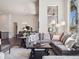 Open-concept living room with large windows, comfortable seating, and dining area in the background at 6970 E Lake Dr, Centennial, CO 80111