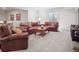 Cozy living room with leather furniture, a wood coffee table, and neutral carpet at 6970 E Lake Dr, Centennial, CO 80111