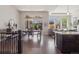 Open-concept living and dining areas with hardwood floors, large windows, and backyard access at 6970 E Lake Dr, Centennial, CO 80111