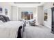 Bright main bedroom with tray ceiling, large windows, and sitting area at 6970 E Lake Dr, Centennial, CO 80111