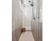 Modern bathroom shower featuring elegant tile, a rainfall shower head, and a built-in bench at 6970 E Lake Dr, Centennial, CO 80111