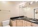 Bathroom with dual sinks, granite countertop and a large mirror at 1827 N Grant St # 800, Denver, CO 80203