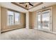 A bedroom features a ceiling fan, a large window, and a balcony at 1827 N Grant St # 800, Denver, CO 80203