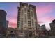 Luxurious high-rise apartment building with multiple balconies against a dramatic pink sky at 1827 N Grant St # 800, Denver, CO 80203