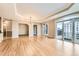 Expansive living area with hardwood floors, tray ceilings, and balcony access at 1827 N Grant St # 800, Denver, CO 80203