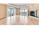 Large living area with a fireplace, hardwood floors, and views from the balcony at 1827 N Grant St # 800, Denver, CO 80203