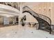 Grand lobby features a staircase, chandelier, and elevator access for residents at 1827 N Grant St # 800, Denver, CO 80203