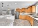 Spacious kitchen with tile floors, stainless steel appliances and custom wood cabinetry at 684 W 99Th Ave, Northglenn, CO 80260