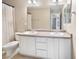 Bathroom with a double sink vanity and a mirror above the sinks with combined bath and shower at 13742 Valentia St, Thornton, CO 80602